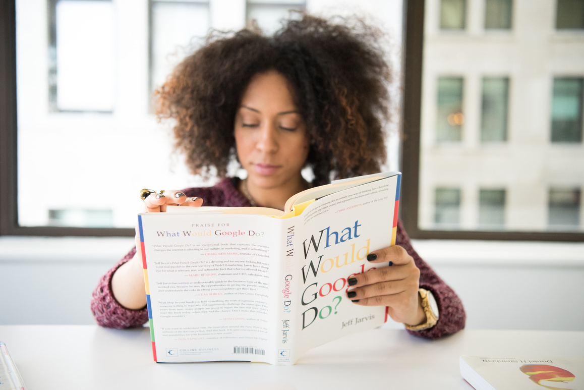 Woman Wearing Maroon Crochet Long-sleeved Shirt Reading What Would Google Do Book